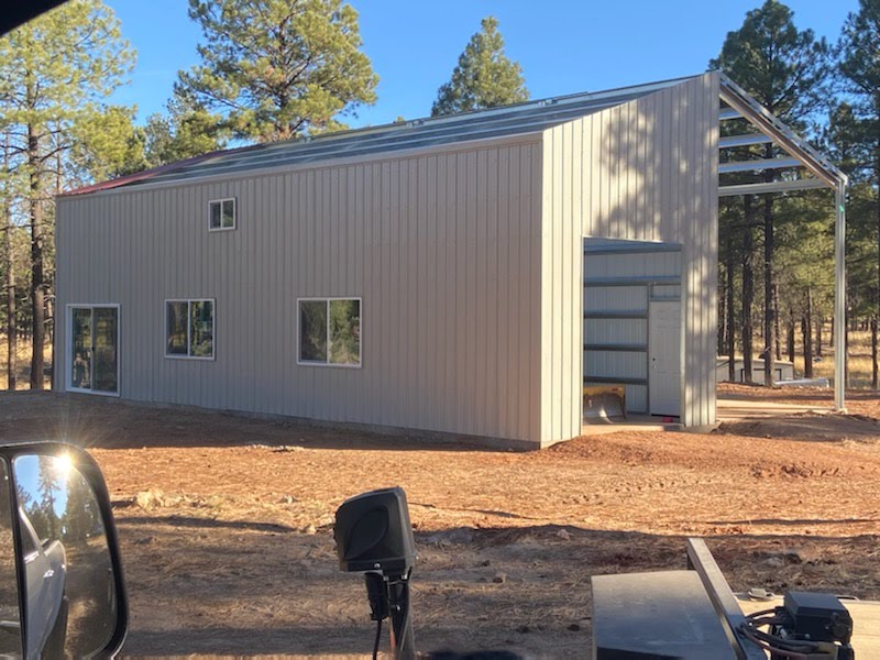 Modern galvanized steel cabins in Flowing Wells, Arizona, surrounded by picturesque desert landscapes and clear blue skies